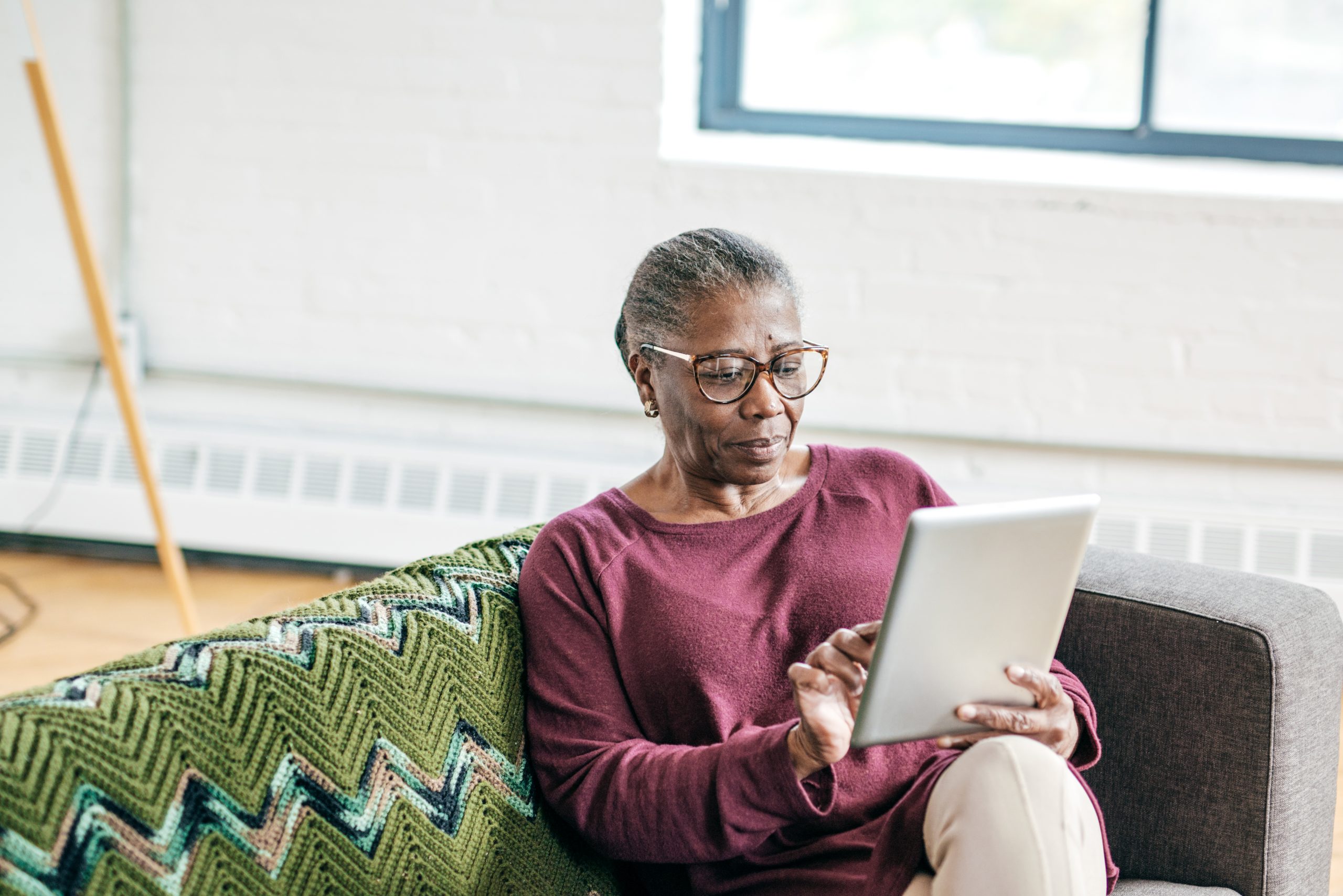 Senior women using tablet for smart home application